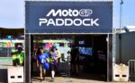 Happy Smile vrijwilliger en kind verlaten samen lachend de MotoGP paddock tijdens de Dutch TT Assen
